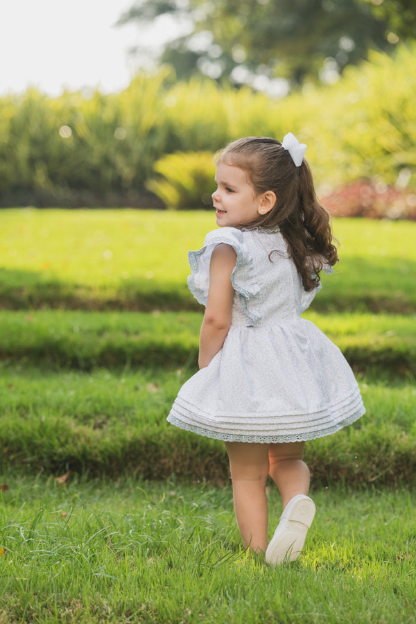 Cannes Dress - Back of white toddler girl dress with grey flower print and ruffle sleeves | Bee•nené