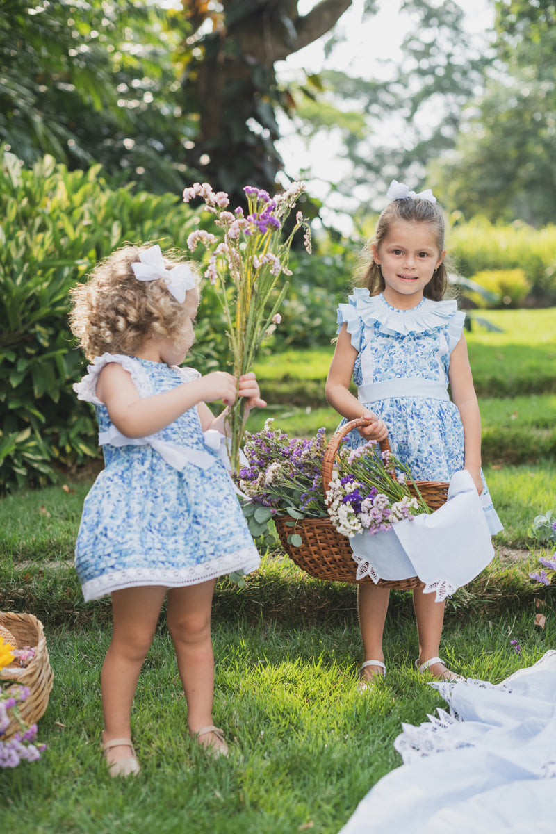 Le Jardin Dress - Blue girl dress in floral pattern with smocking and ribbon detail | Bee•nené